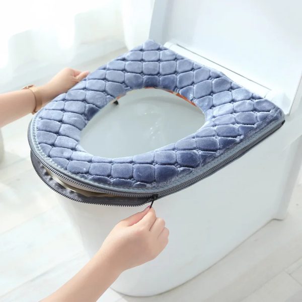 Close-up image of a toilet seat and lid covered with the thickened toilet seat cover set. The cover is a plush material, and the toilet appears clean and inviting.