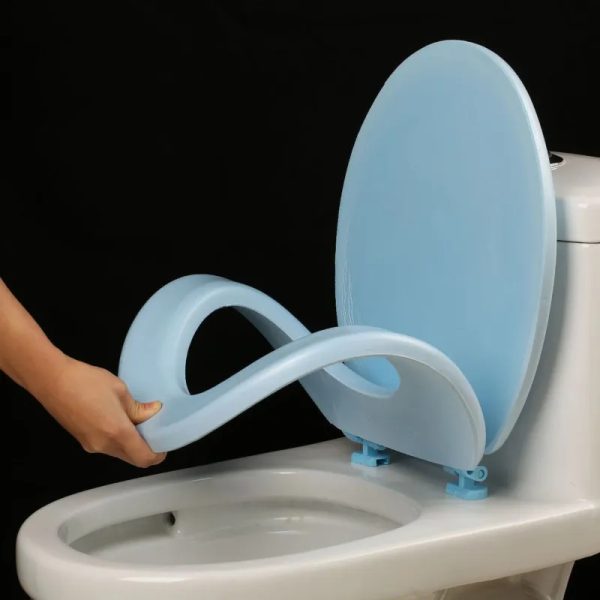 A close-up image of a white Universal Waterproof EVA Toilet Seat Cushion placed on a standard toilet seat. The soft, cushioned material is visible, and the contoured shape shows it conforms to the toilet seat.