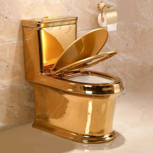 Photo of a luxurious bathroom interior featuring a gleaming gold toilet and a single roll of toilet paper.