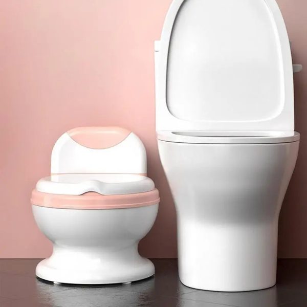 Happy toddler using a colorful foldable potty training seat on a regular toilet.