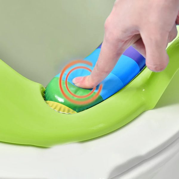 Close-up photo of the friendly frog face on the blue toilet seat, designed to make potty training more fun for kids.