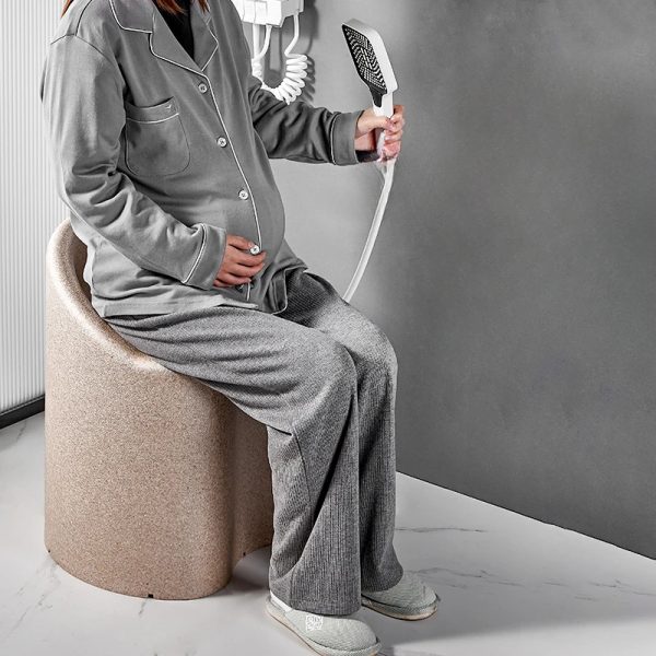Adult relaxing safely in a comfortable shower chair with a non-slip design.