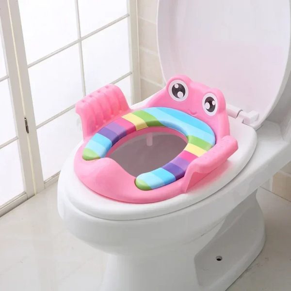 Happy toddler sitting comfortably on a safe potty seat with armrests.